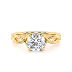 The ring under soft lighting, showcasing the diamond's fire and the gold's warm glow